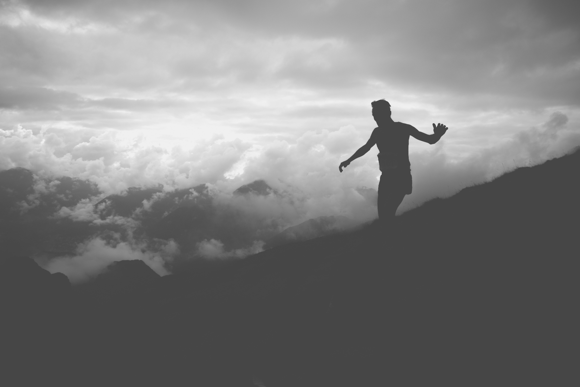 Runner on a mountain ridge above the clouds